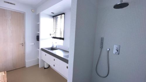 霍恩Kaap Hoorn Club Bed en Breakfast的白色的浴室设有水槽和淋浴。