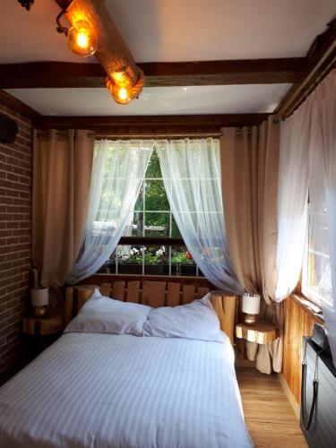 库瑞尼卡慕斯卡Pokój SERCE KRYNICY的一间卧室设有一张大床和一个窗户。