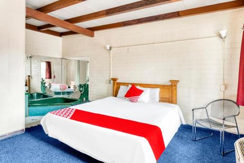 拉斯维加斯OYO Oasis Motel Las Vegas I-15的卧室配有一张白色大床和浴缸