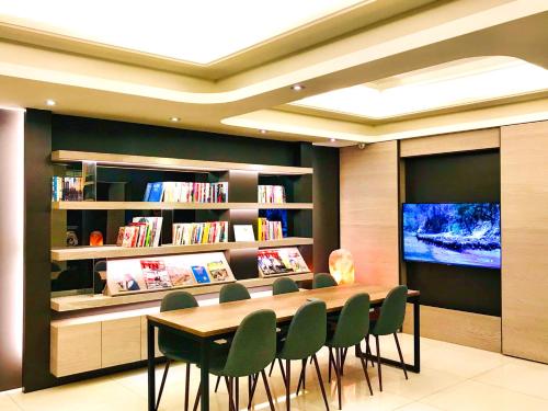 土城区旅居文旅土城馆的图书馆配有桌椅和电视