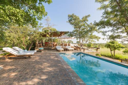 克拉塞利尔自然保护区Baobab Ridge的一个带椅子的游泳池以及一座房子