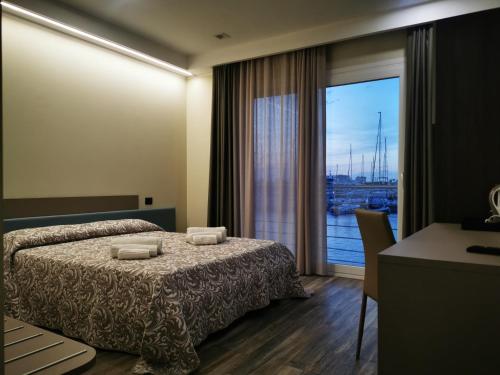 维博瓦伦蒂亚码头SARACENO HOTEL的酒店客房设有一张床和一个大窗户