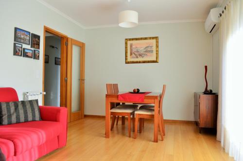 波尔图音乐美景公寓的客厅配有桌子和红色沙发