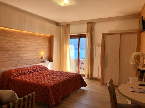 加尔尼亚诺帕拉吉纳酒店的酒店客房配有红色的床和一张桌子