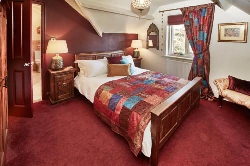 惠特比Dillons of Whitby的一间卧室配有一张大床和红地毯