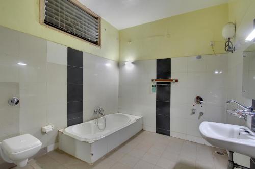 BāgalkotKanthi Resorts Badami的带浴缸、卫生间和盥洗盆的浴室