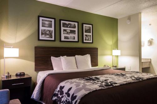 亚特兰大Sleep Inn Atlanta Airport的酒店客房,设有床铺和绿色的墙壁