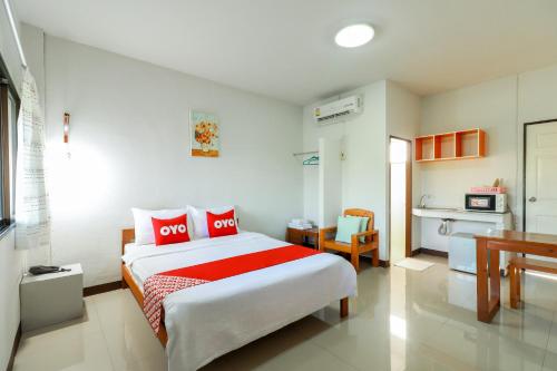 南奔OYO 421 Dnk Baan Suan的一间带大床的卧室和一间厨房