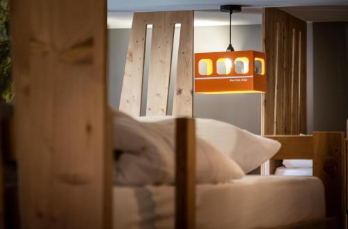 圣莫里斯堡Hotel Base Camp Lodge - Bourg Saint Maurice的一间设有一张带灯和灯的床的房间
