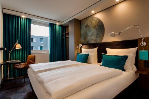 纽伦堡纽伦堡-普拉瑞1号汽车酒店的一间卧室配有一张带绿色窗帘的大床