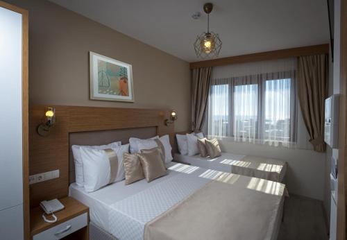 伊斯坦布尔Zeyn Otel Istanbul的一间卧室设有两张床和大窗户