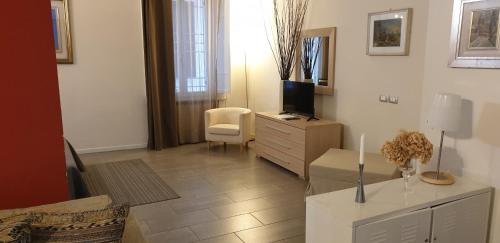 曼托瓦雅格拉住宅酒店的客厅配有电视和带电视器的梳妆台。