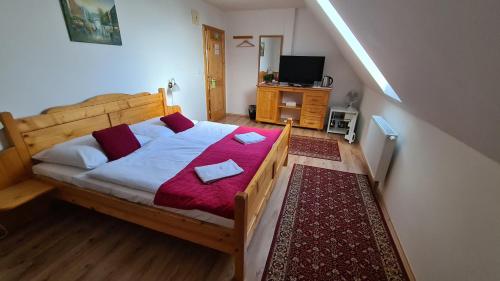 塞内奇科利巴酒店的一间卧室配有一张带红色毯子的木床
