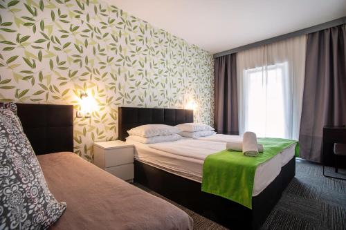 科佩尔比奥酒店的酒店客房设有两张床和一张绿桌。
