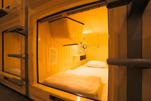 东京汤岛胶囊旅馆（只限男性）的一间小房间,里面设有两张床