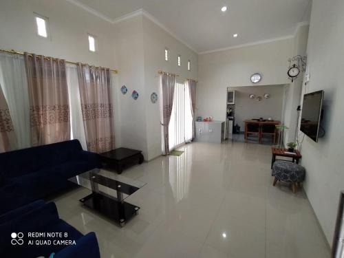 巴图Villa Allesha Batu的客厅配有蓝色的沙发和桌子