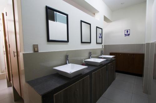 利马Lima House Hostel的浴室设有2个水槽和2面镜子
