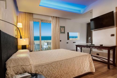卡托利卡帕克酒店的一间卧室配有一张床、一张书桌和一个窗户。