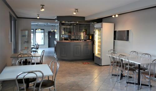 福里斯特维尔Motel Quatre Saisons的一间带桌椅和柜台的餐厅