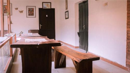 日惹nDalem Joglo Krawitan Syariah的客房设有木桌和长凳。