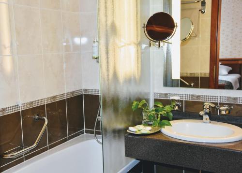 杜布罗夫尼克卡兹别克精品酒店的一间带水槽、浴缸和镜子的浴室