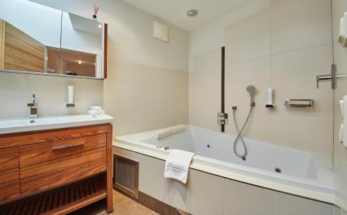 萨尔巴赫沙赫纳酒店的白色的浴室设有浴缸和水槽。