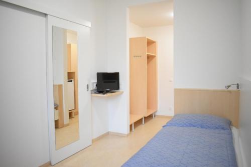 林茨城市索维亚酒店的一间带床和电视的小卧室