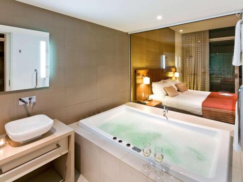 曼哲拉斯贝尔曼德拉酒店的带浴缸和床的浴室