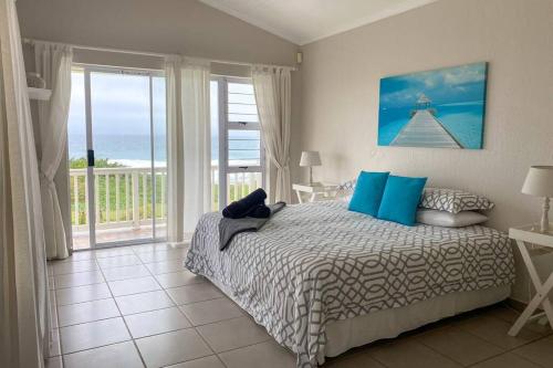 爱德华港Tamassa Holiday Home on the Beach, in Port Edward的一间卧室配有一张床,享有海景