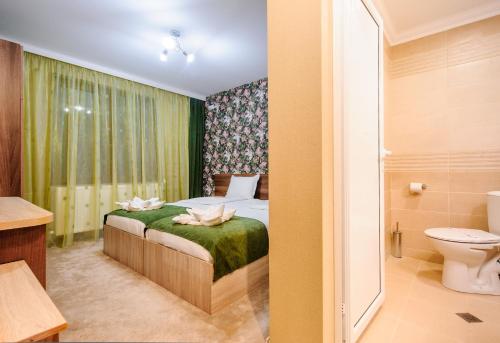 MiladinowziПиргуля的一间卧室配有一张床,浴室设有卫生间