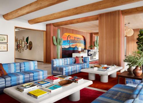 土桑Graduate Tucson的客厅配有蓝色的沙发和桌子
