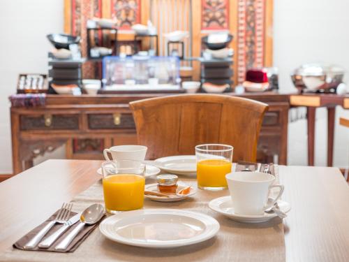 瓦讷科拉瑟别墅酒店Spa的一张桌子,上面放有盘子和橙汁杯
