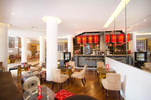 曼谷China Town Hotel - SHA Plus Certified的一间带桌椅的餐厅和一间酒吧