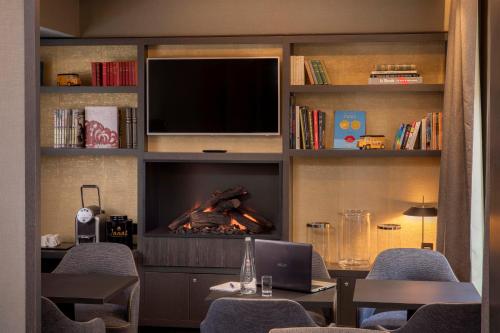 巴黎道努歌剧酒店的客厅设有壁炉和电视。