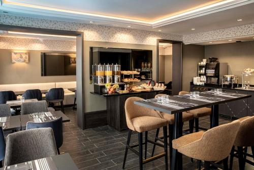 巴黎道努歌剧酒店的一间带桌椅的餐厅和一间酒吧