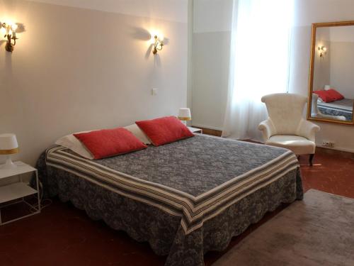 福卡尔基耶Chambre D'hôte La Beaudine的一间卧室配有一张带两个红色枕头的床