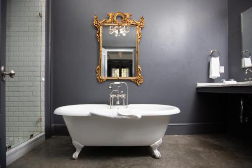 布埃纳维斯塔Surf Hotel & Chateau的浴室设有白色浴缸及镜子