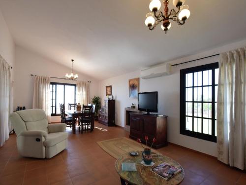 阿尔加罗沃Belvilla by OYO Casa Loli的客厅配有沙发、椅子和电视