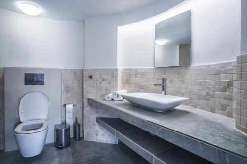 卡沃斯Island Kavos的一间带水槽、卫生间和镜子的浴室