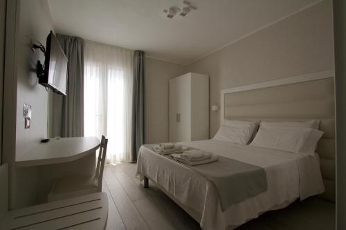 兰佩杜萨La Guitgia Rooms的一间卧室配有一张床、一个浴缸和一个水槽