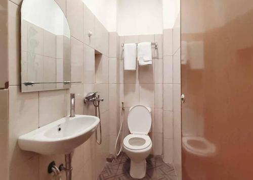 Pulauberayan DadapRedDoorz Plus @ Jalan Letda Sujono Medan 2的一间带水槽、卫生间和镜子的浴室