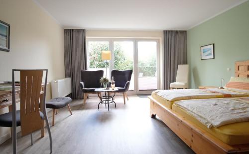 圣彼得奥尔丁Hus op de Diek的卧室配有一张床和一张桌子及椅子
