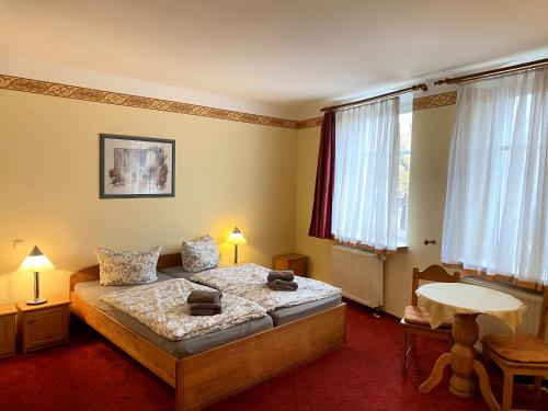格罗斯吉恩滕豪斯贝尔格酒店的卧室配有床、桌子和窗户。