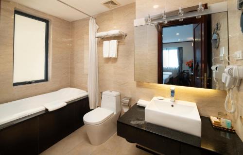 河内Hanoi Larosa Hotel的浴室配有盥洗盆、卫生间和浴缸。