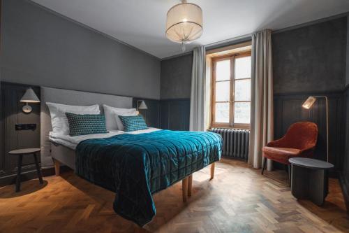 夏蒙尼-勃朗峰古斯塔维阿酒店的卧室配有床、椅子和窗户。