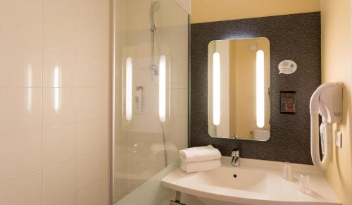格勒诺布尔格勒诺布尔中心巴士底宜必思酒店的浴室配有盥洗盆和带镜子的淋浴