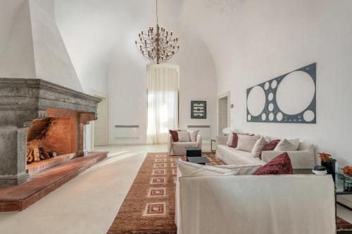 滨海波利尼亚诺Villa Torre Bianca by Emily Hotels的带沙发和壁炉的客厅