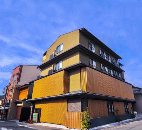 京都HIZ HOTEL Kyoto-Nijo Castle的街上的黄色和棕色建筑