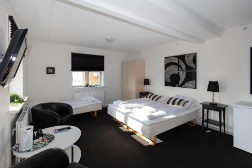 斯卡恩Skagen Hotel Annex的一间酒店客房,设有两张床和电视