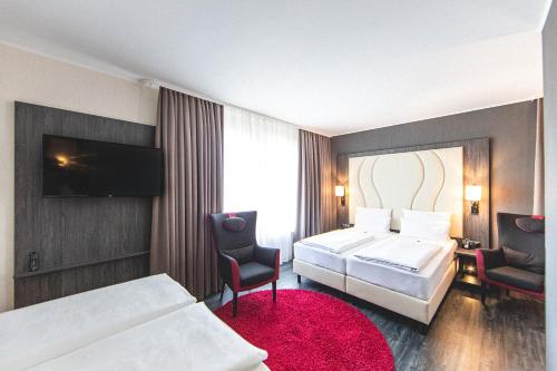 PLAZA Premium Parkhotel Norderstedt客房内的一张或多张床位